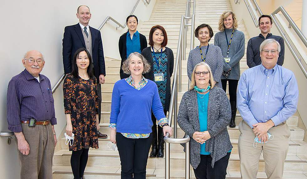 Linda O'Brien (center-right) is met with the rest of the GI team as a farewell.