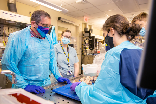 Dr. Lieberman (left) leading a brain conference with Dr. Pinarbasi (right) and residents.