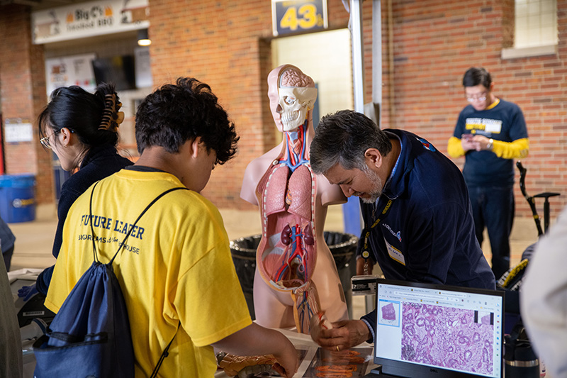 Riccardo Valdez working with a youth during the event.