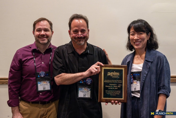 Dr. Ul Balis accepts Distinguished Service Award from incoming president Dr. Ronald Jackups and outgoing president Dr. Ji Yeon Kim.