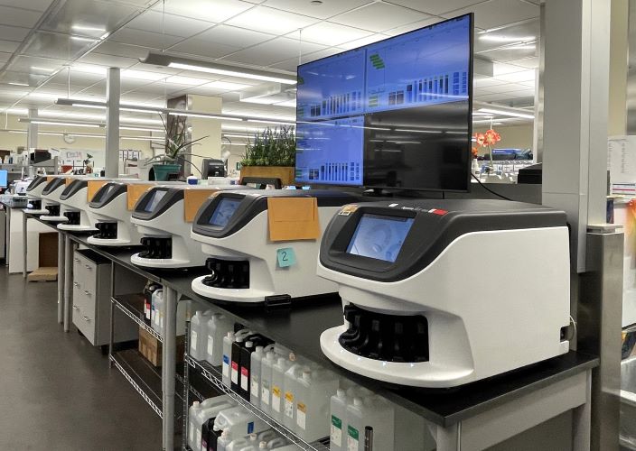 A bank of digital scanners sits within the histology laboratory, streamlining workflows.