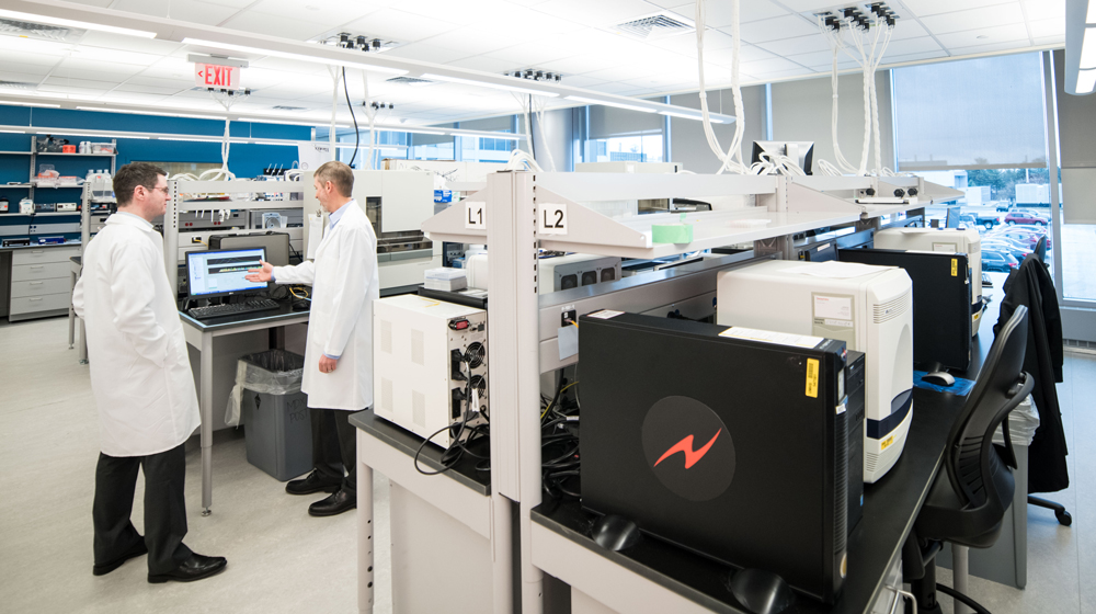 Noah Brown (left) and Bryan Betz (right) work in the Molecular Diagnostics laboratory at NCRC.