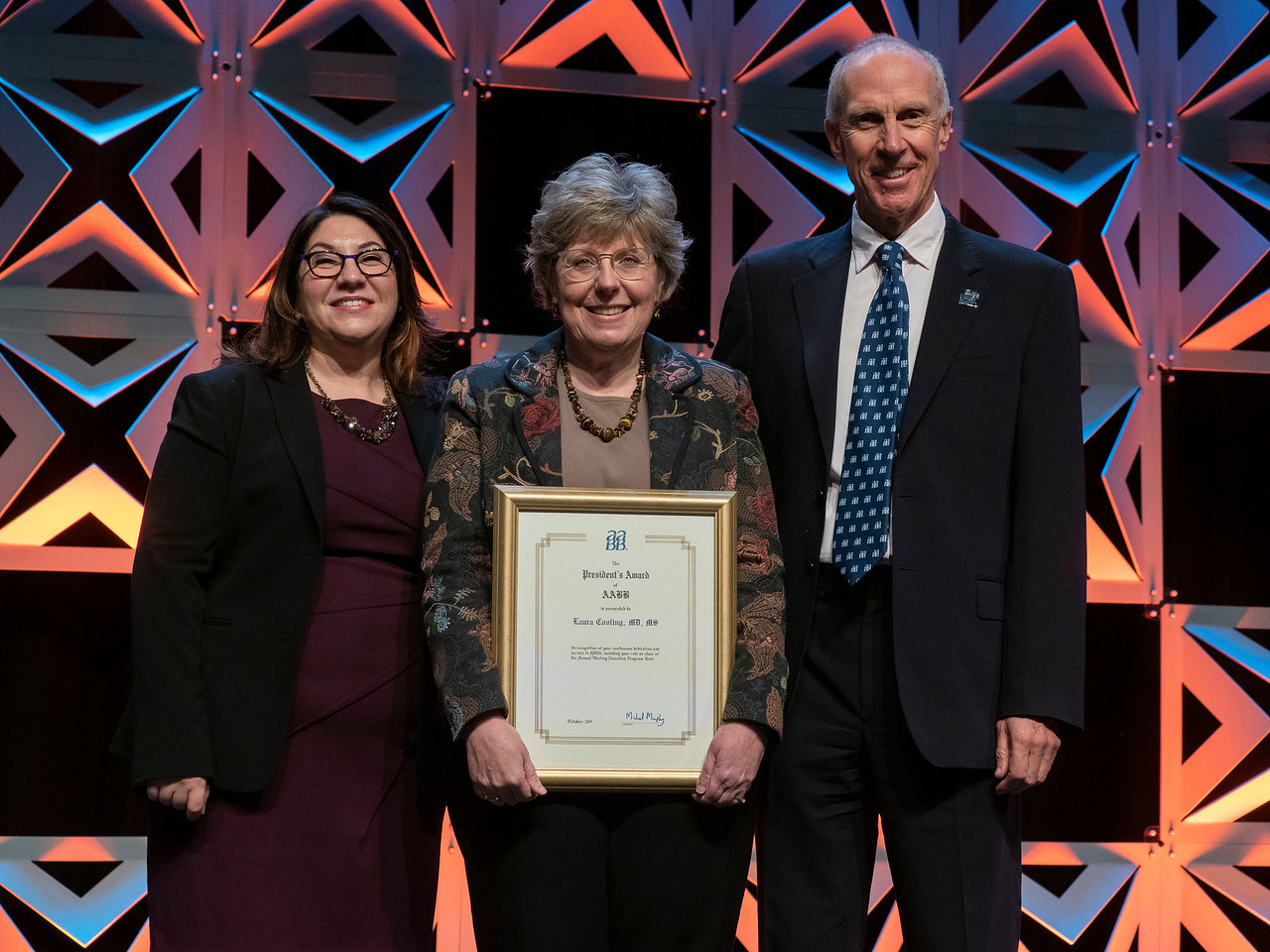 Laura Cooling receiving recognition by the AABB president at the keynote address